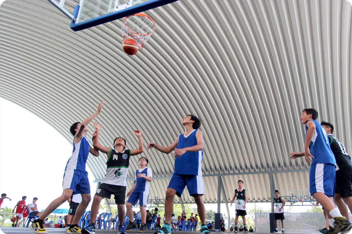 Pupils go for a rebound during a basketball match at the FOBISIA Games
